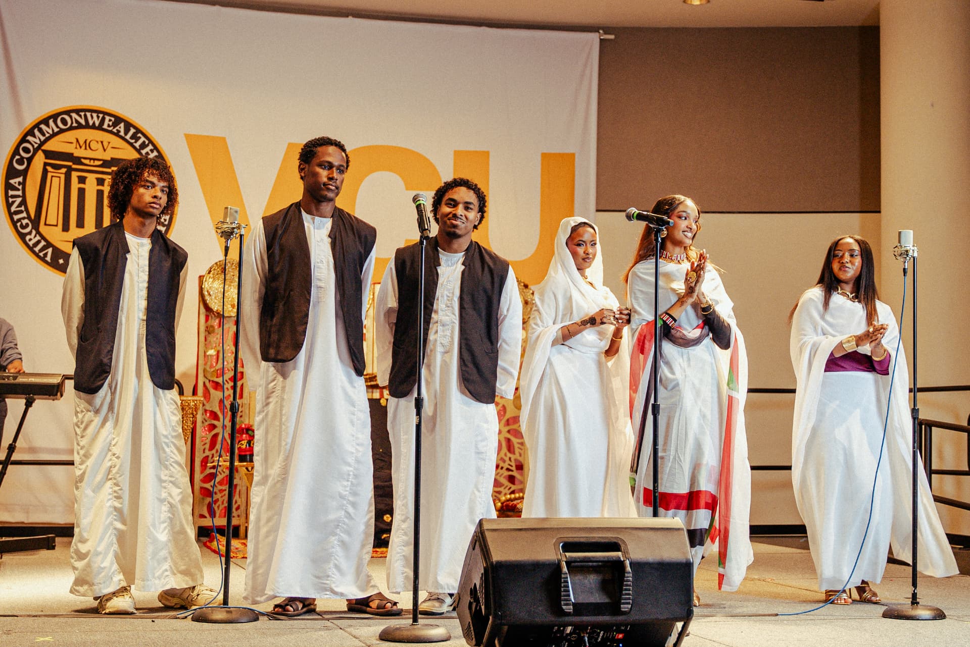 SSA at VCU students in traditional Sudanese dress performing on stage at Taste of Sudan